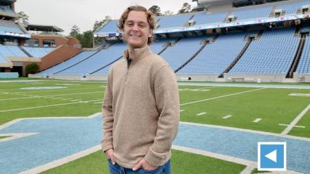 Kyle Lobenhofer stands on field at Kenan Stadium